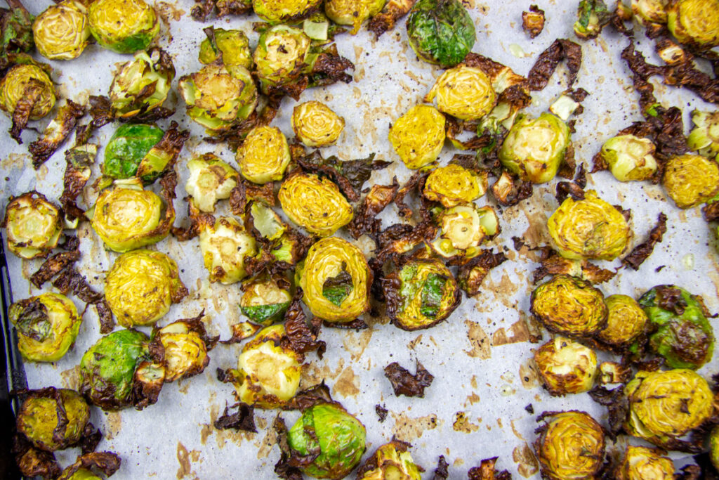 Close up of caramelized brussels sprouts cooked on sheet pan.