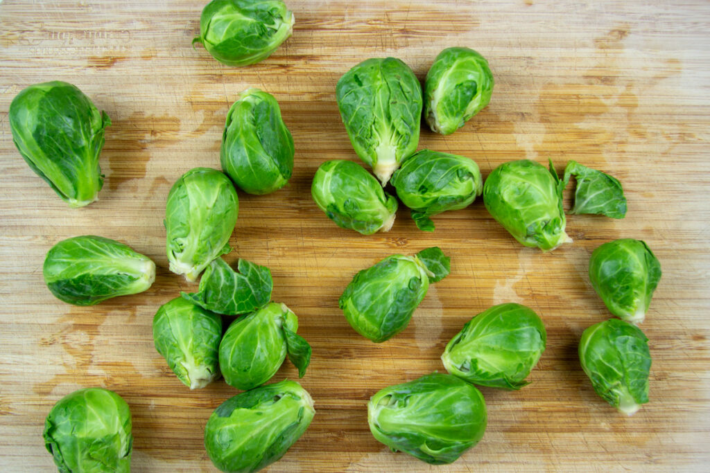 Brussels sprouts whole on cutting board.