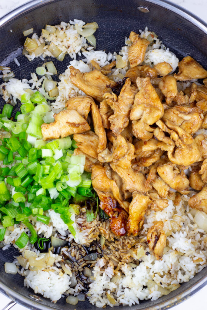 chicken and scallions added to thai fried rice